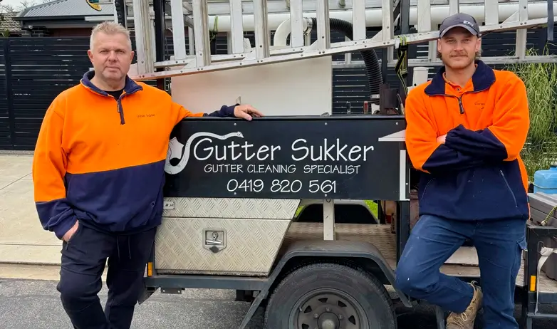 Business Owners Pic Gutter Sukker About us page - Local Gutter Cleaners Adelaide image of the owners Andrew and Joel standing at the side of their work trailer.