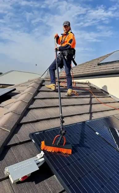 Joel Cleaning Panels on a Roof Pic